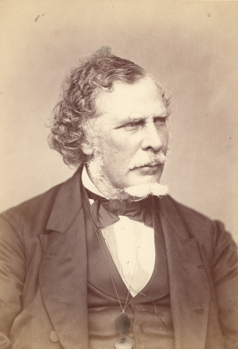 An archival portrait image of a man dressed in Victorian-era attire