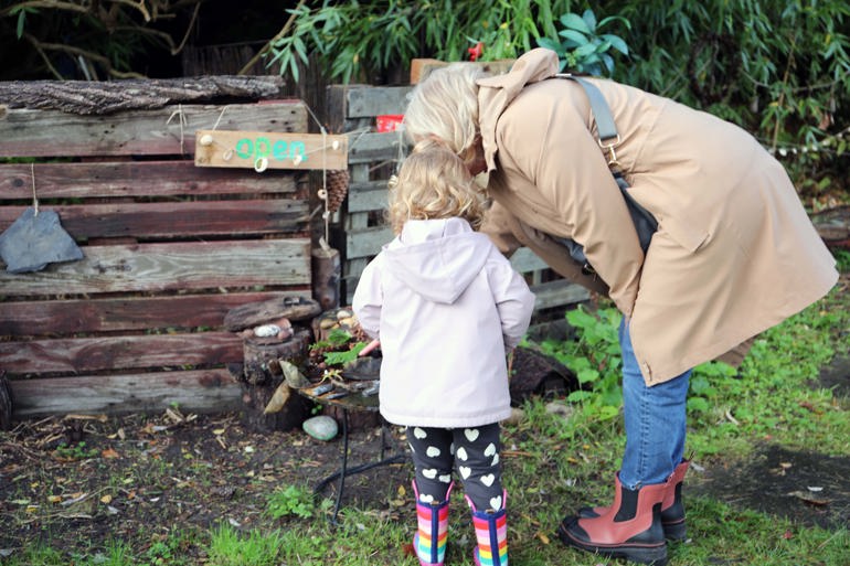 Parent and toddler exploring Garden together.